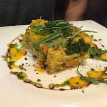 Cake of Millet with smoked eggplant tofu, kale and cabbage with carrot sauce and sweet potato.